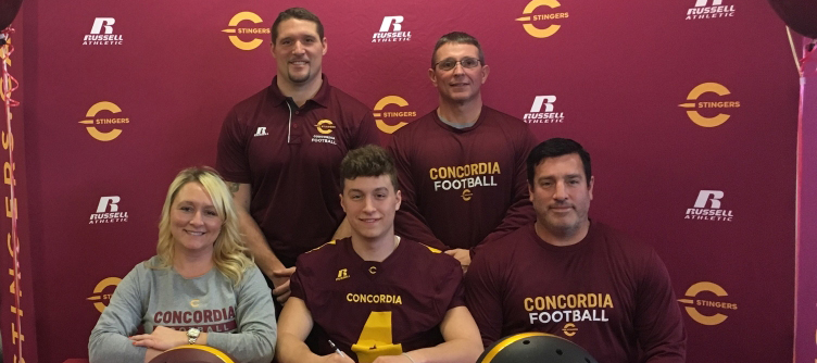 Jacob Filgate with his parents and head coaches.